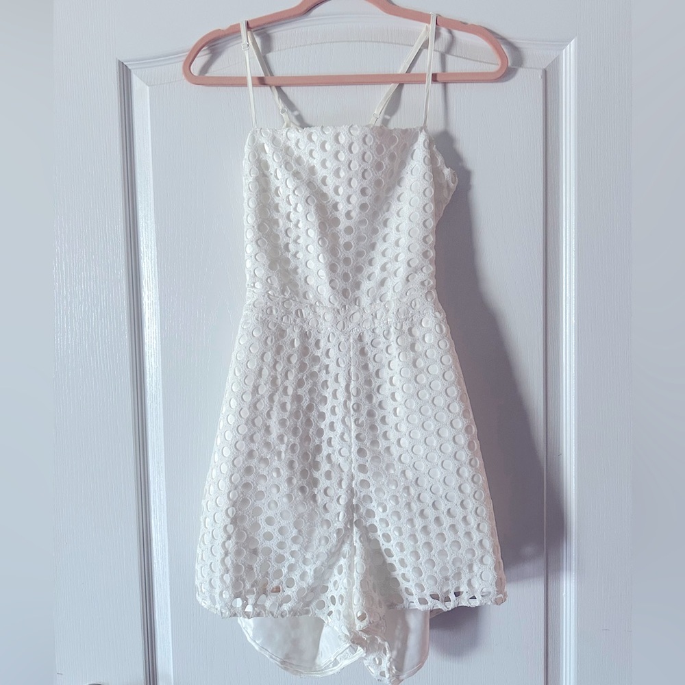 White romper size large. Untreated makeup stain on shorts